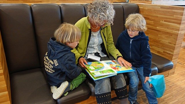 Grandmother reading wordless picture books AAC learners